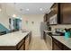 Modern kitchen featuring granite countertops, stainless steel appliances, and a breakfast bar at 8912 Rhodes St, Kissimmee, FL 34747