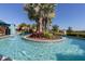 Picturesque lazy river with island landscaping, inviting inner tubes, and surrounding palm trees at 8912 Rhodes St, Kissimmee, FL 34747