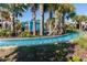 Community lazy river with palm trees and lush landscaping around the pool with resort-style amenities at 8912 Rhodes St, Kissimmee, FL 34747