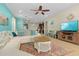 Open-concept living room with modern furniture, a large TV, and views of the kitchen and dining area at 8912 Rhodes St, Kissimmee, FL 34747