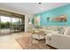 Living room with tile floors, stylish rug, modern sofa, and view to pool at 8912 Rhodes St, Kissimmee, FL 34747