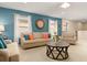 Comfortable living room with beige furnishings, stylish wood coffee table, and ample natural light at 8912 Rhodes St, Kissimmee, FL 34747