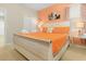 Bright bedroom with a king-size bed, warm orange accents, and comfortable furnishings, creating a relaxing ambiance at 8912 Rhodes St, Kissimmee, FL 34747