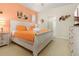 Comfortable bedroom featuring a king-size bed, a dresser with TV, and soft lighting, creating a tranquil retreat at 8912 Rhodes St, Kissimmee, FL 34747