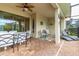 Covered outdoor living space featuring multiple seating arrangements and exterior access at 8912 Rhodes St, Kissimmee, FL 34747