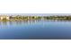 Scenic community pond with a fountain and lush landscaping surrounding new houses in the neighborhood at 8912 Rhodes St, Kissimmee, FL 34747