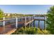Beautiful wooden pier with railing overlooking a community pond with fountain and new homes in background at 8912 Rhodes St, Kissimmee, FL 34747