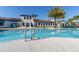 Community pool with clear water, ample lounge seating, and a view of the clubhouse at 8912 Rhodes St, Kissimmee, FL 34747