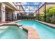 Private screened pool and spa area featuring lush landscaping at 8912 Rhodes St, Kissimmee, FL 34747
