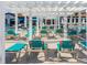 Resort-style pool deck with plenty of lounge chairs under a pergola by the community bar and lounge at 8912 Rhodes St, Kissimmee, FL 34747
