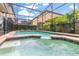 Private screened pool area featuring lush landscaping at 8912 Rhodes St, Kissimmee, FL 34747