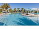 Luxury pool featuring palm trees, cabanas, and lounge seating, perfect for relaxation and entertaining at 8912 Rhodes St, Kissimmee, FL 34747