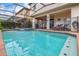 Private screened pool area featuring an attached spa at 8912 Rhodes St, Kissimmee, FL 34747