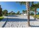 Bright community sand volleyball court adjacent to the sidewalk with palm trees along the edge of the court at 8912 Rhodes St, Kissimmee, FL 34747