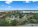 Stunning aerial view showcases a lakeside community with lush greenery and beautiful homes under a bright blue sky at 9324 Carolview Way, Orlando, FL 32836