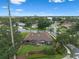 Aerial view of a neighborhood street and a house with manicured lawn and mature trees at 9324 Carolview Way, Orlando, FL 32836