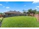 Lush backyard with manicured lawn, patio, and a brick wall adding privacy at 9324 Carolview Way, Orlando, FL 32836