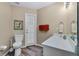 Bathroom with gray vinyl flooring, white toilet, vanity and a mirror at 9324 Carolview Way, Orlando, FL 32836