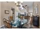 Dining area with glass table, modern chandelier, and kitchen view at 9324 Carolview Way, Orlando, FL 32836
