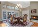 Dining room features elegant table, chairs, and fireplace for inviting dining and entertaining at 9324 Carolview Way, Orlando, FL 32836