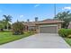 Charming home with a well-manicured lawn, mature landscaping, and an attached two car garage at 9324 Carolview Way, Orlando, FL 32836
