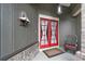 Close-up of the inviting red double front doors featuring white curtains and a lovely porch area at 9324 Carolview Way, Orlando, FL 32836