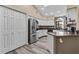 Modern kitchen featuring stainless steel appliances, white cabinets, and wood-look floors at 9324 Carolview Way, Orlando, FL 32836