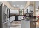 Bright kitchen featuring stainless steel appliances, white cabinets, and wood-look floors at 9324 Carolview Way, Orlando, FL 32836