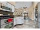 Open kitchen with stainless appliances, breakfast bar, and views to the dining area at 9324 Carolview Way, Orlando, FL 32836