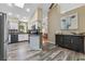 Bright kitchen featuring stainless steel appliances, white cabinets, and stylish flooring at 9324 Carolview Way, Orlando, FL 32836
