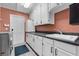 Laundry room with white cabinets and a sink with chrome faucet at 9324 Carolview Way, Orlando, FL 32836