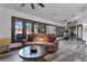 Spacious living area featuring a plush sofa, modern coffee table, and access to the backyard at 9324 Carolview Way, Orlando, FL 32836