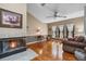 Cozy living room with a fireplace, hardwood floors, and ample natural light from large windows at 9324 Carolview Way, Orlando, FL 32836