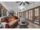 Large living area with ample seating, hardwood floors, and sliding doors to a dining area at 9324 Carolview Way, Orlando, FL 32836