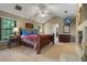 Comfortable main bedroom featuring a fireplace, neutral colors, and great natural lighting at 9324 Carolview Way, Orlando, FL 32836