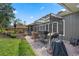 Back patio with pergola, grill, table and manicured landscaping at 9324 Carolview Way, Orlando, FL 32836