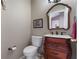 Charming powder room features a unique vanity, decorative mirror, and stylish fixtures at 9324 Carolview Way, Orlando, FL 32836