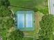 Overhead shot of dual well-maintained outdoor tennis courts within a gated enclosure at 9324 Carolview Way, Orlando, FL 32836
