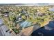 Aerial view of a gated tennis court and surrounding green space in a neighborhood at 9324 Carolview Way, Orlando, FL 32836