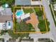 An aerial view of a home that features a private pool, lush landscaping, and solar panels on the roof at 9543 Buxton, Orlando, FL 32817