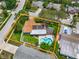 This aerial view showcases a home with a private pool, lush backyard, and solar panels on the roof at 9543 Buxton, Orlando, FL 32817