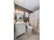 Well-lit bathroom featuring a mosaic backsplash, modern vanity, updated fixtures, and a shower with curtain at 9543 Buxton, Orlando, FL 32817
