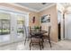 Cozy dining area with tile flooring, natural lighting from French doors, and seating for four guests at 9543 Buxton, Orlando, FL 32817