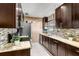 Modern kitchen featuring granite countertops, stainless steel appliances, and stylish dark wood cabinetry at 9543 Buxton, Orlando, FL 32817