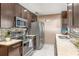 Updated kitchen boasts granite countertops, stainless steel appliances, and dark cabinetry, perfect for the home chef at 9543 Buxton, Orlando, FL 32817