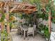 Outdoor pergola adorned with vibrant flowers and greenery creating a shady, inviting dining or seating area at 9543 Buxton, Orlando, FL 32817