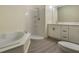 Clean bathroom with corner shower, soaking tub, double sink vanity, and modern fixtures throughout at 1065 Universal Rest Pl, Kissimmee, FL 34744