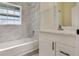 Updated bathroom featuring a tub with shower and a vanity with a stylish countertop at 1065 Universal Rest Pl, Kissimmee, FL 34744