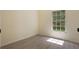 Bright bedroom featuring light-colored walls, wood-look floors, and a window offering natural light at 1065 Universal Rest Pl, Kissimmee, FL 34744