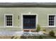 Charming home with a double-door entry, windows with white trim, and a well-manicured garden at 1065 Universal Rest Pl, Kissimmee, FL 34744